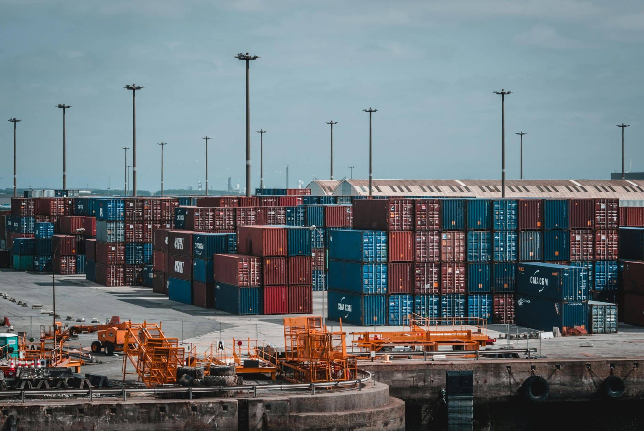 Shipping containers stacked at port terminal for logistics operations
